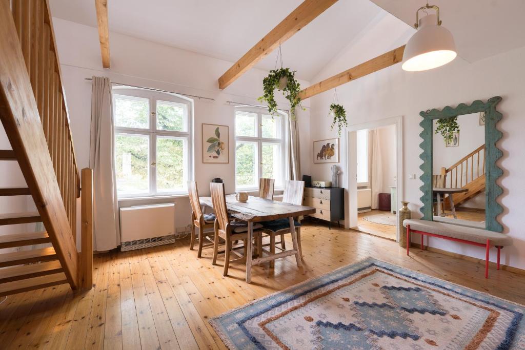 a dining room with a table and chairs in a room at Design Apartments - Innenstadt, Apt 2 in Potsdam