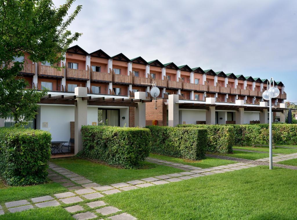 a large building with bushes in front of it at Residence Il Patio in Iseo