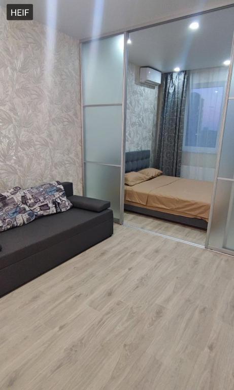 a bedroom with a bed and a mirror at 51 жемчужина Аркадія in Odesa