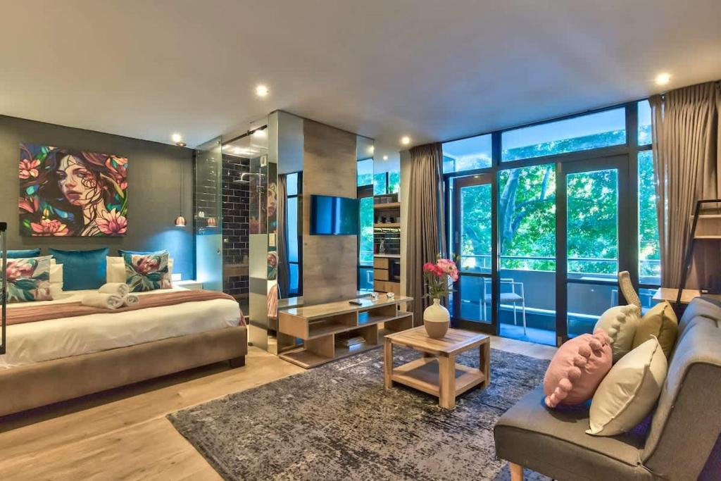 a living room with a bed and a couch at St Martini Gardens Studio in Cape Town