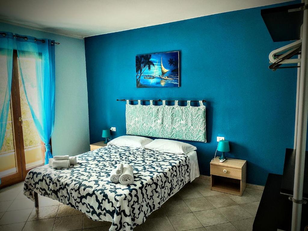 Postel nebo postele na pokoji v ubytování Residenze L'Isola Surf House