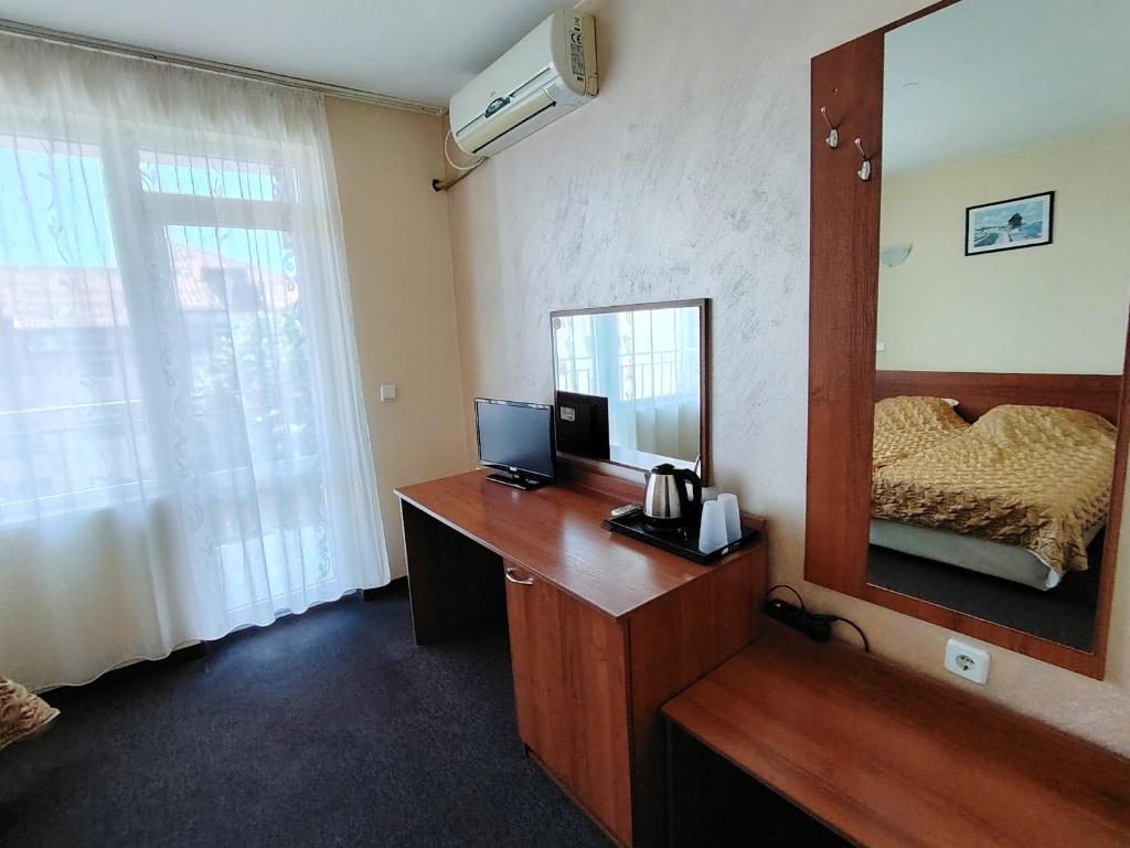 Postel nebo postele na pokoji v ubytování Sandor Hotel