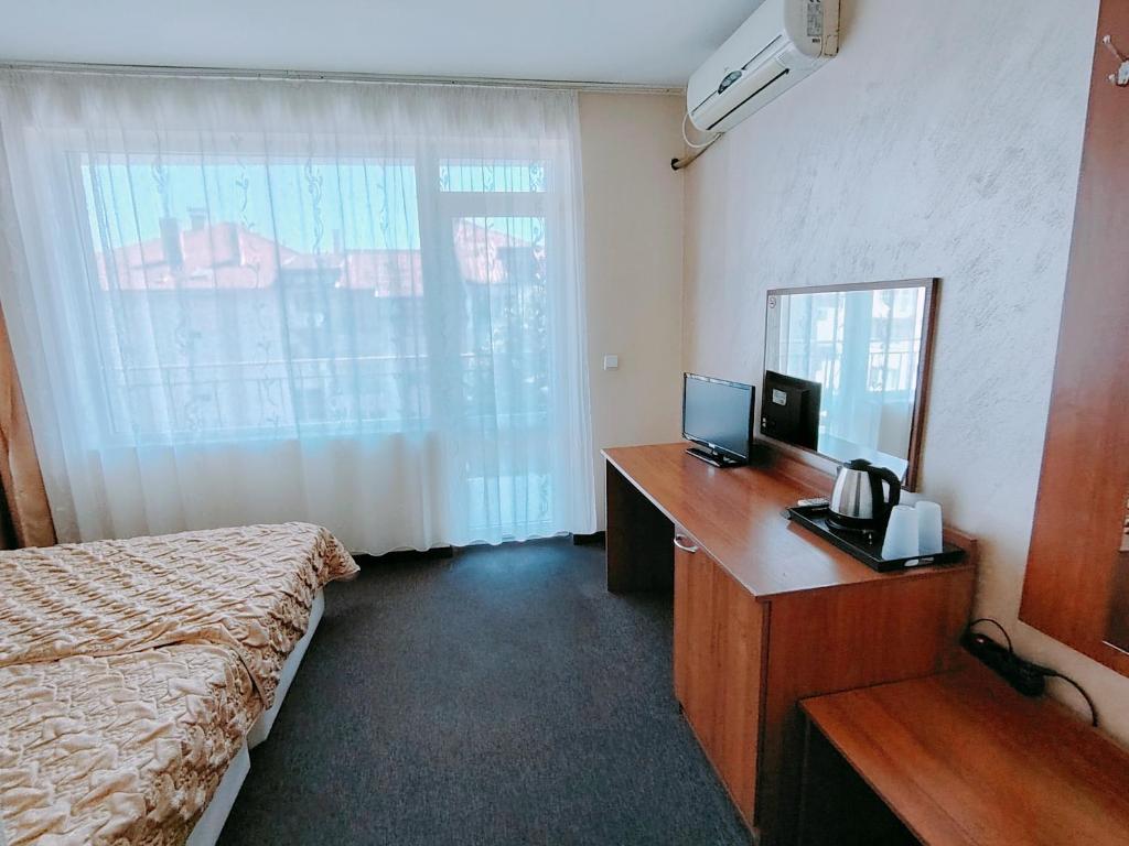 Postel nebo postele na pokoji v ubytování Sandor Hotel