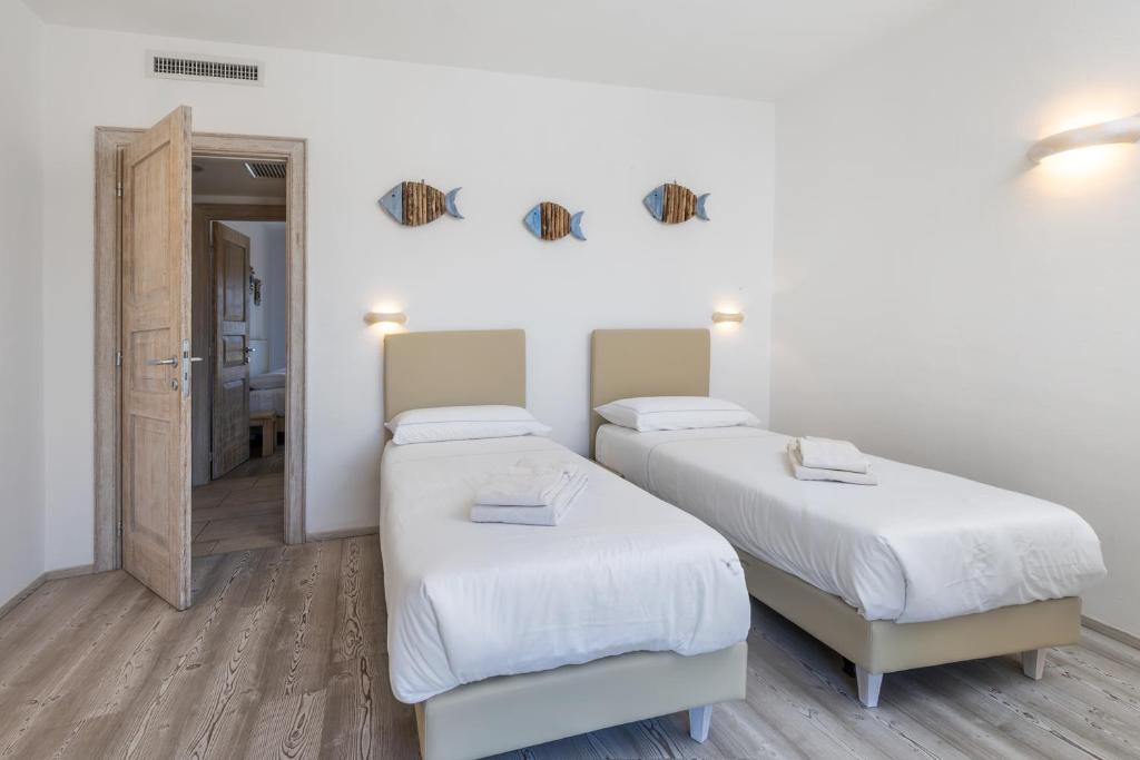 Postel nebo postele na pokoji v ubytování The Square Rooms and Suites