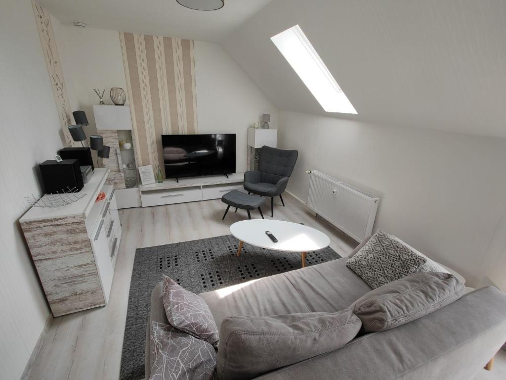 a living room with a couch and a tv at Urlaubszuhause 
