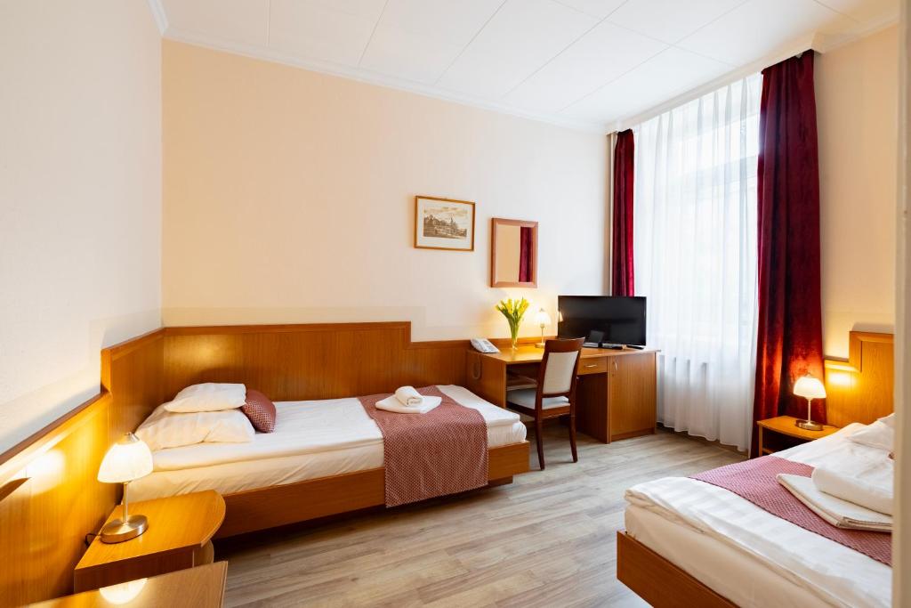 Postel nebo postele na pokoji v ubytování Hotel Pannonia