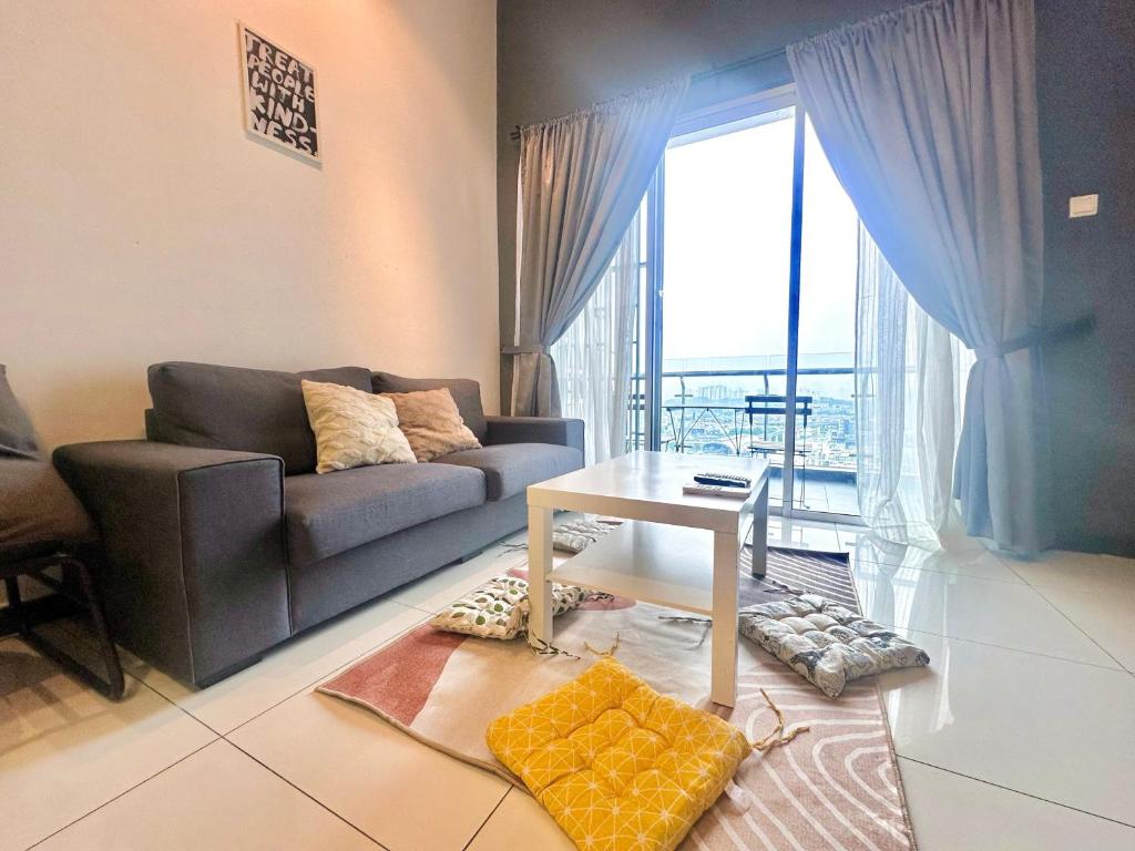 a living room with a couch and a table at Puchong Skypod 9pax Near Sunway in Puchong