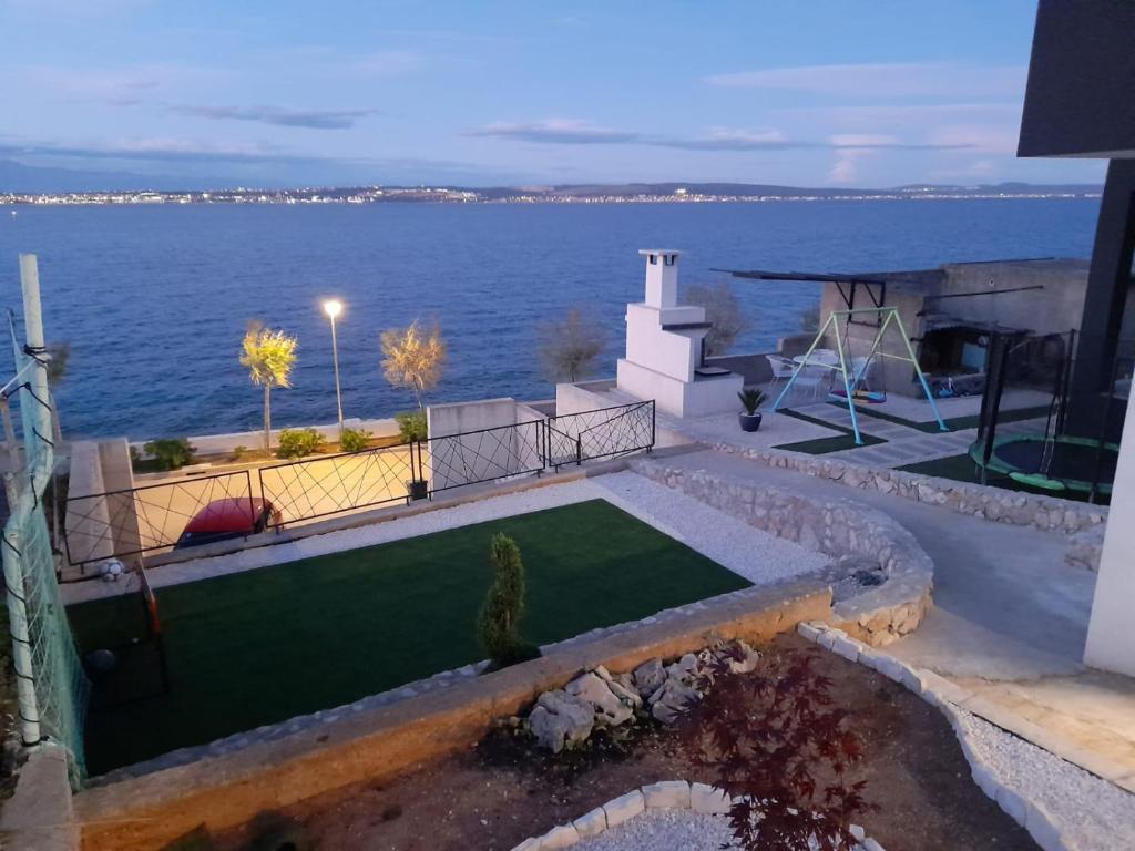 a house with a golf course in front of the water at Island dream in Kali