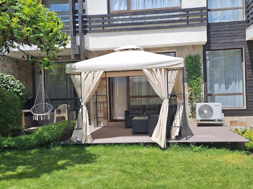 a gazebo in the yard of a house at 2 Bdr Garden Apt with Spa near Ski and Golf in Razlog