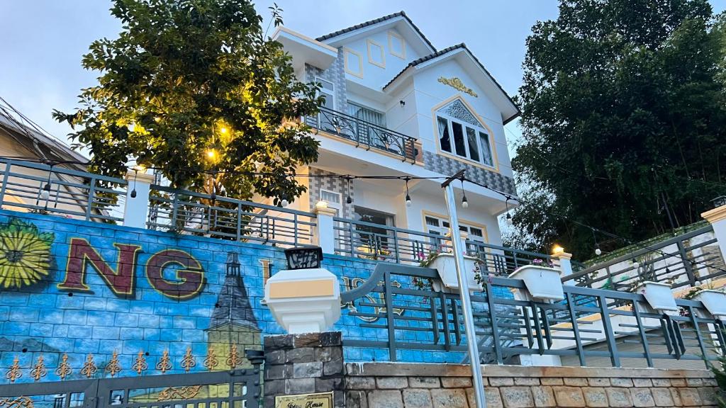 a white house with a no sign on the wall at Bonghouse in Ấp Ða Lợi