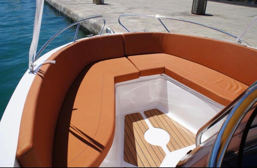 um barco na água com um deck de madeira em Speedboat Tours Our Lady Of The Rocks, Perast, Mamula Island and Blue Cave swiming em Tivat