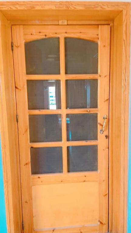 a wooden door with glass windows in a room at Chalet in Ain Sokhna