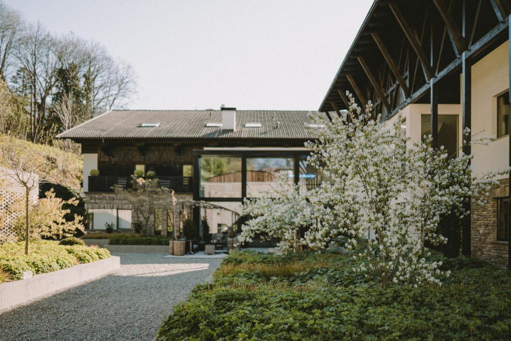 a house with a garden in front of it at Hotel KÜGLERHOF in Tirolo