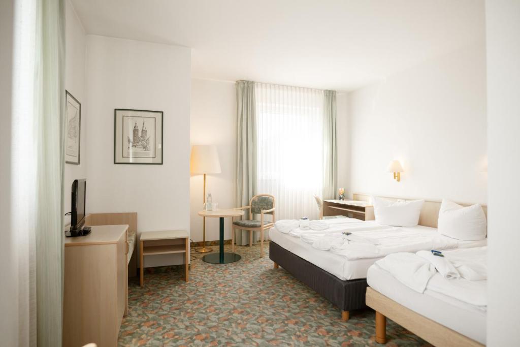 Postel nebo postele na pokoji v ubytování Hotel Astor