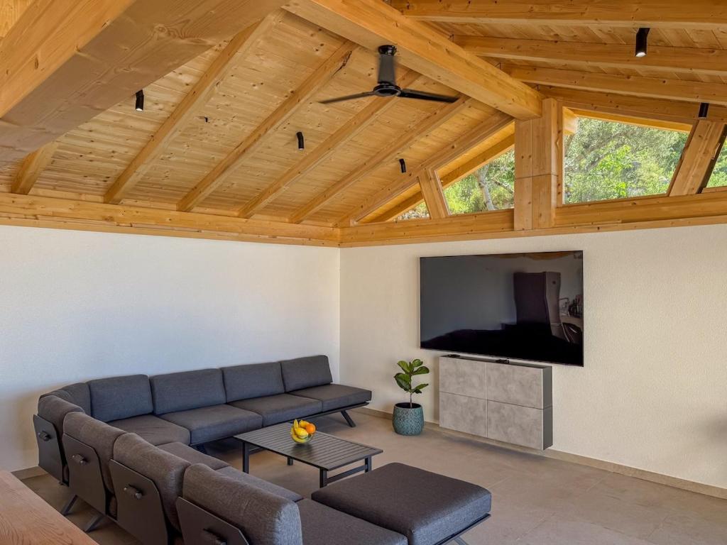 a living room with a couch and a flat screen tv at Villa Olive retreat in Krilo