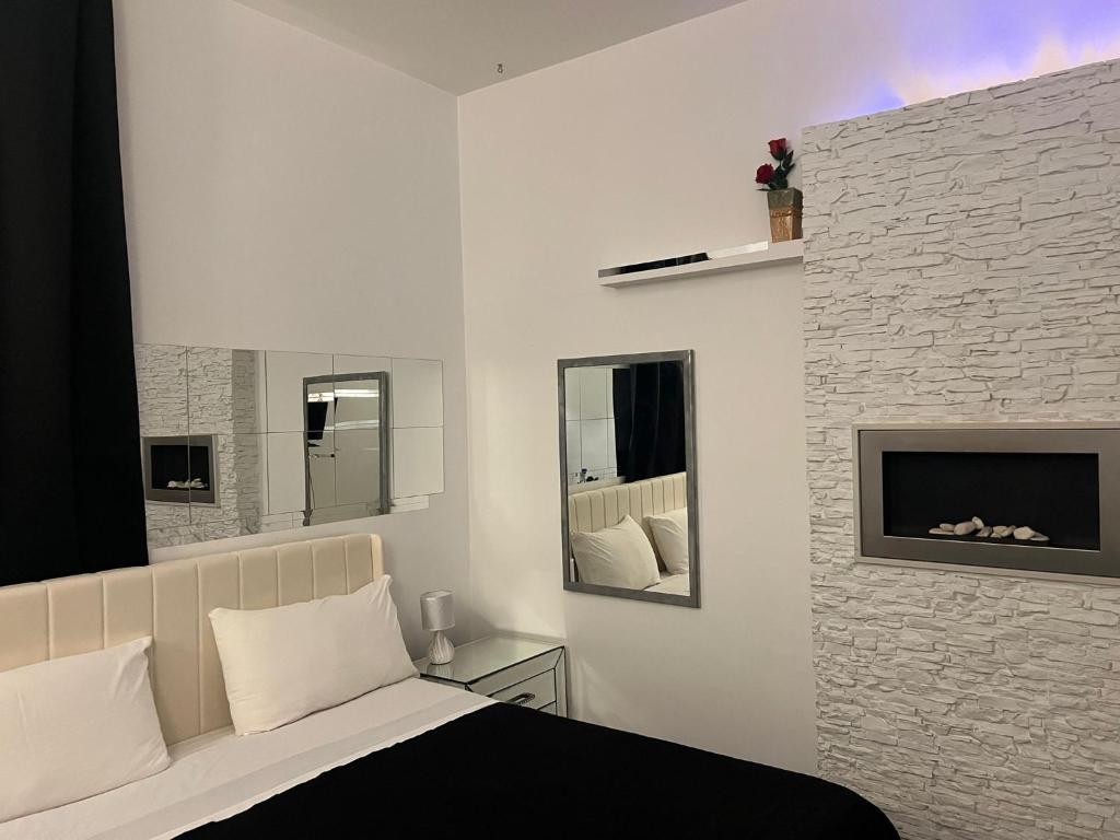 a bedroom with a bed and a fireplace at Palese Profumo di Mare in Santo Spirito