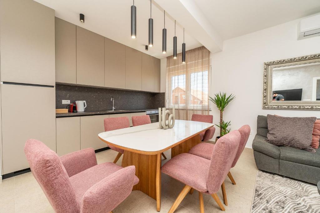 a kitchen and living room with a table and chairs at Apartment Anna - free private parking in Zadar