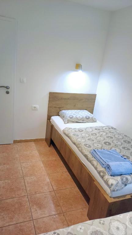 Postel nebo postele na pokoji v ubytování Apartments Planina pod Sumikom