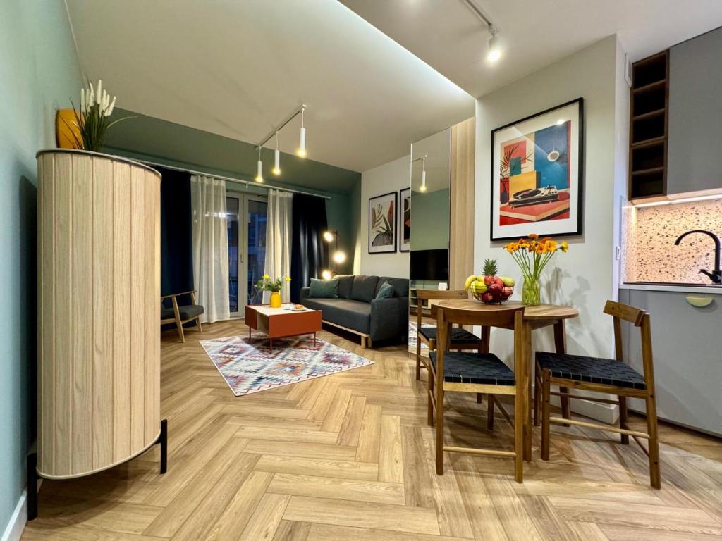 a living room with a table and a couch at Apartament ShipYard Loft Gdańsk by TriApart in Gdańsk