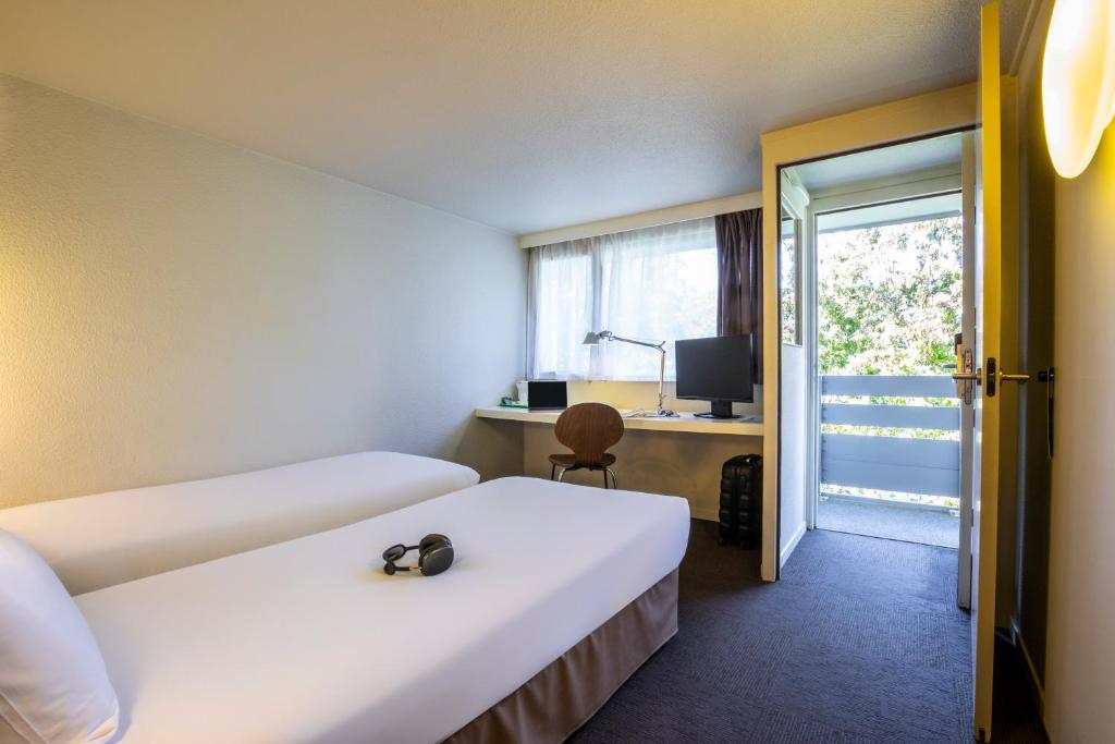 Postel nebo postele na pokoji v ubytování Hôtel Campanile Strasbourg Aéroport Lingolsheim