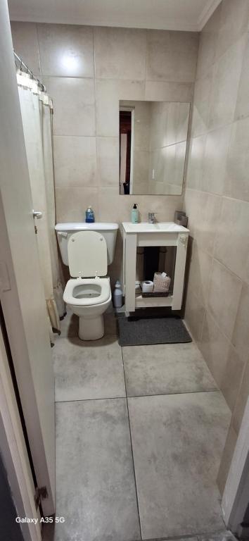 a bathroom with a white toilet and a sink at Ana home's in Mar del Plata