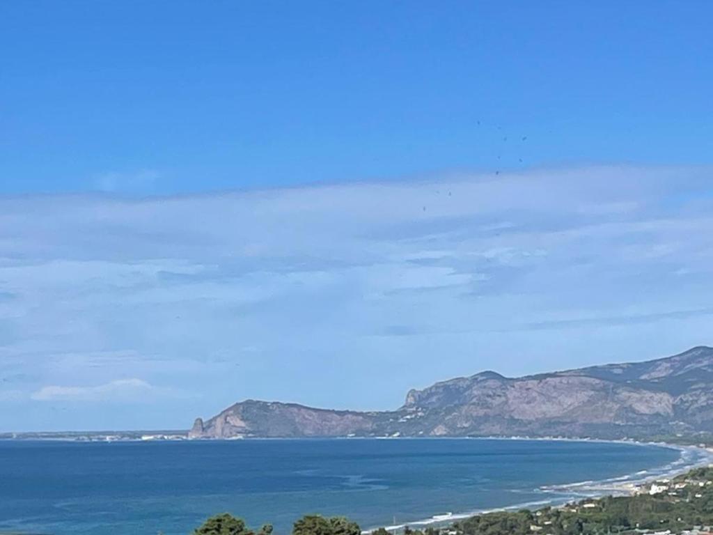 a view of the ocean with mountains in the background at Hotel Belvedere in Sperlonga