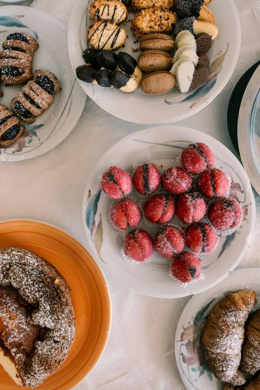 a table with plates of pastries and plates of desserts at Hotel Belvedere in Sperlonga