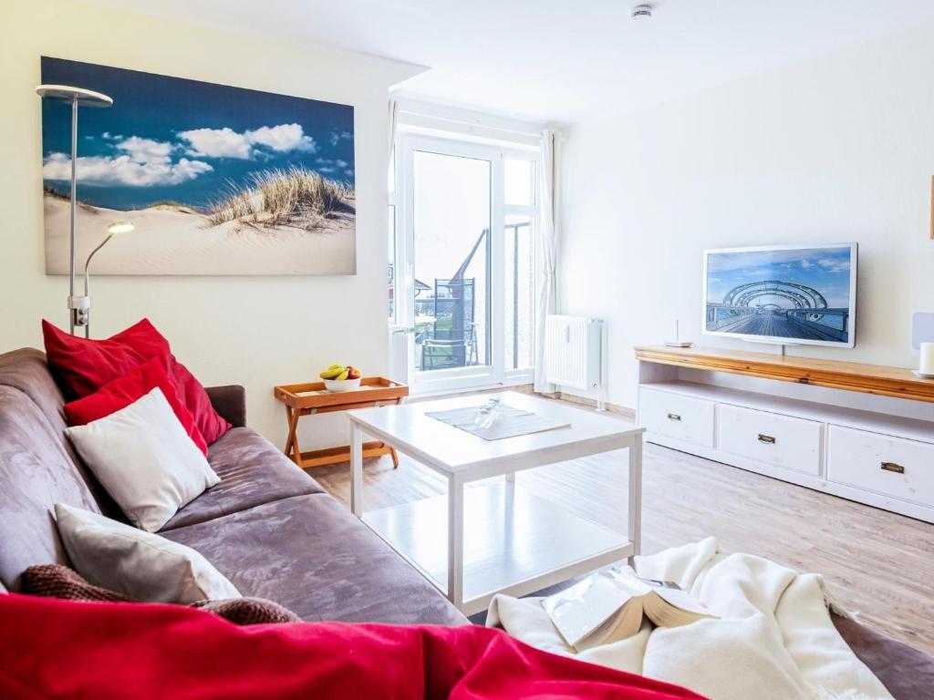 a living room with a couch and a table at Kaiserhof 18 Wohnung 16 in Kellenhusen