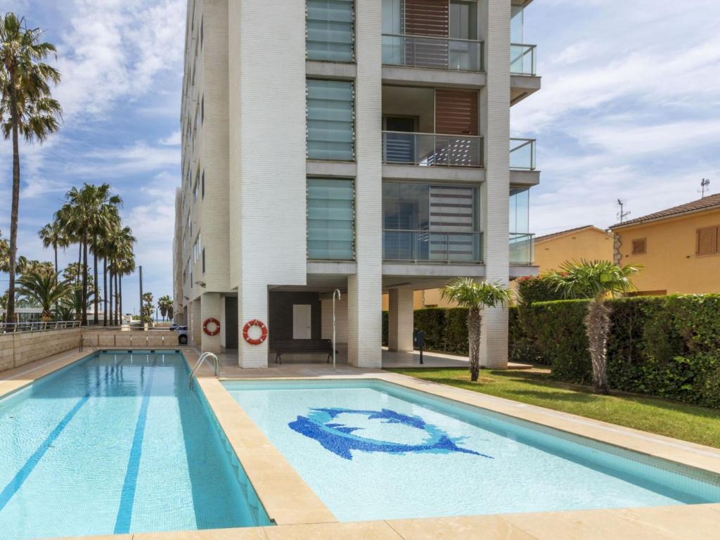 a swimming pool in front of a building at Apartment Ambassador by Interhome in Peñíscola