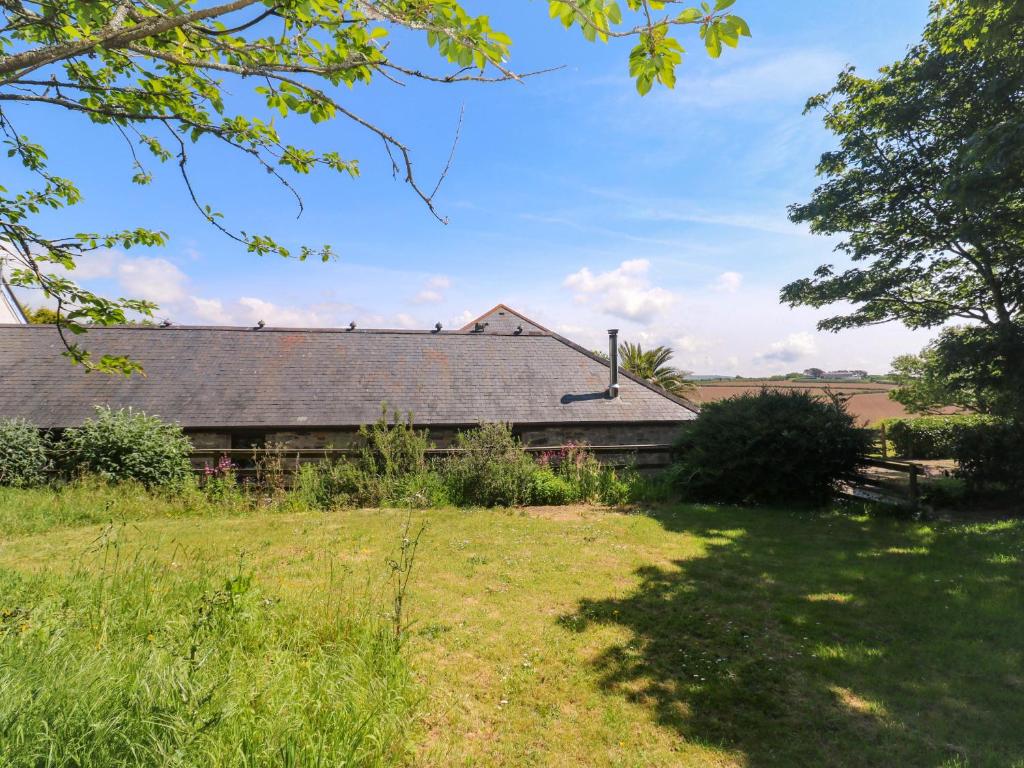 a house in a field with a yard at The Shippen in Penzance