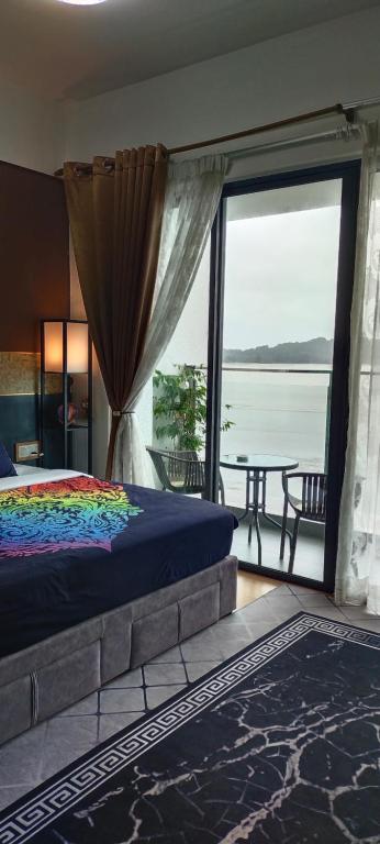 a bedroom with a bed and a view of the water at SwissBelResidence Studio With King Bed in Kuantan