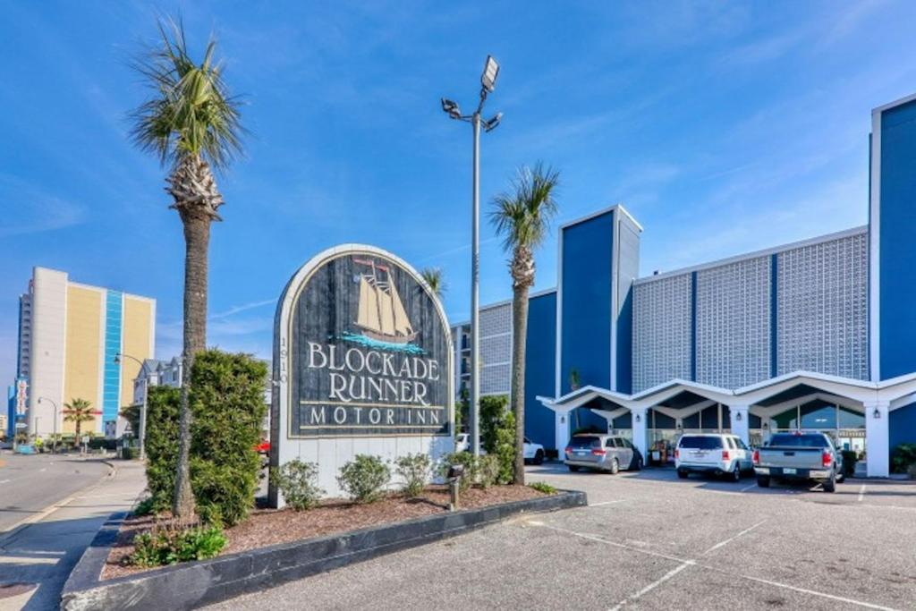 a sign in a parking lot in front of a hotel at Blockade Runner in Myrtle Beach
