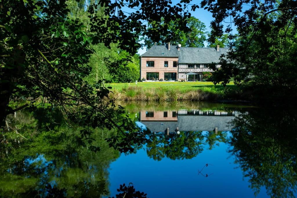 YébleronLe Manoir de la campagne的水中反射的大房子
