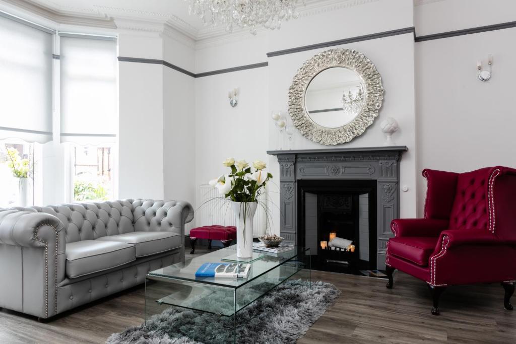 a living room with a couch and a fireplace at Coast B&B in Bexhill