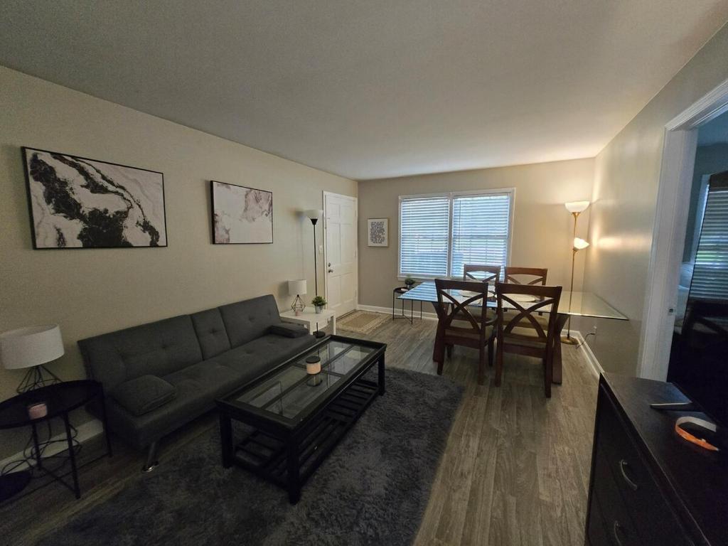 a living room with a couch and a table at Perfect flat in Central Fayetteville, GA in Fayetteville