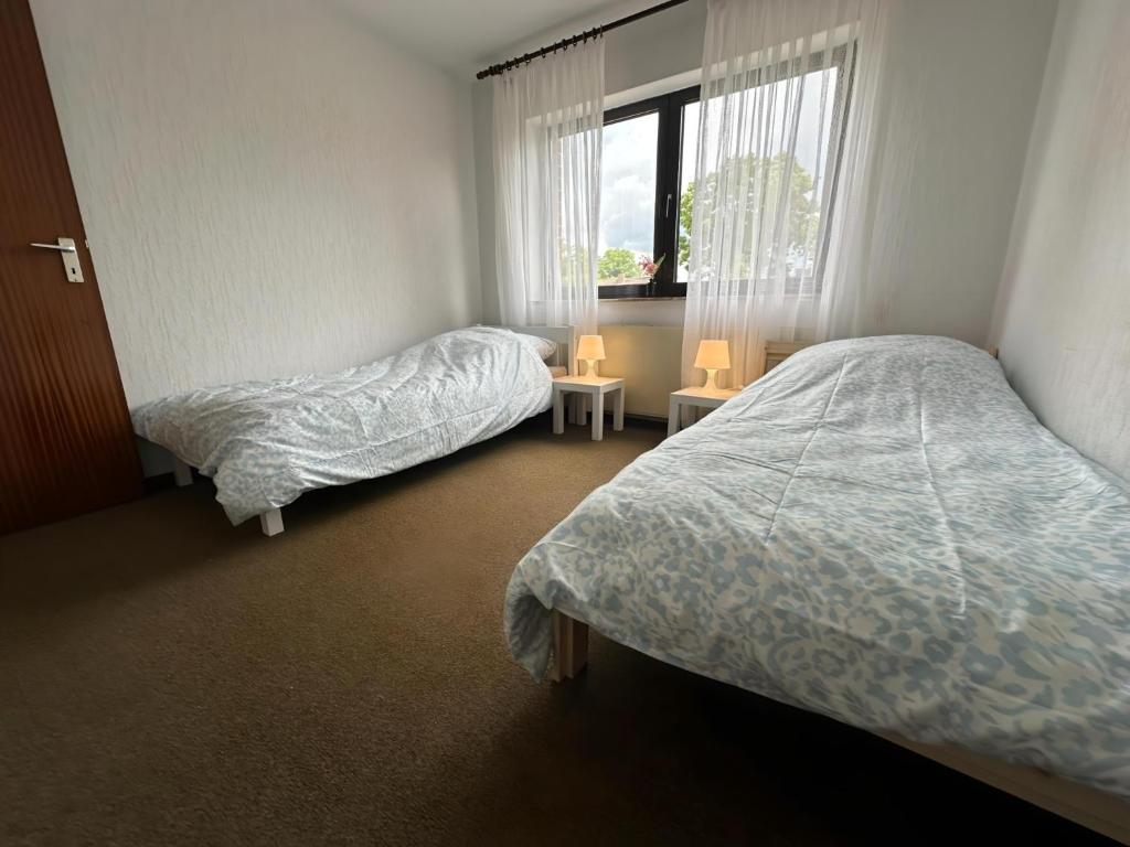 Ένα ή περισσότερα κρεβάτια σε δωμάτιο στο Apartment Ruhepause III Ruhig & Geräumig