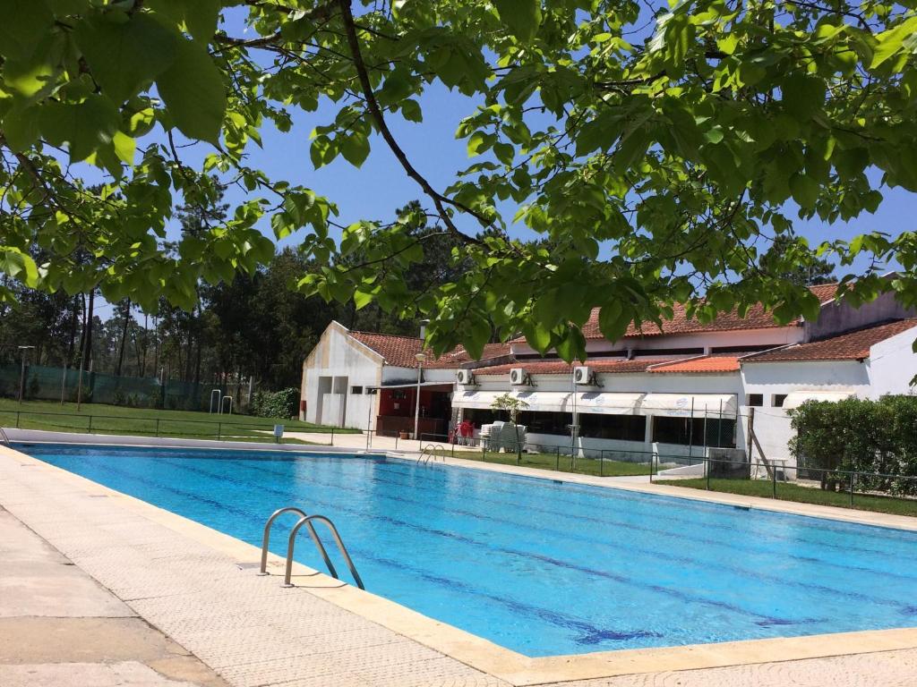 a large blue swimming pool next to a building at Valbom by Campigir in Sesimbra