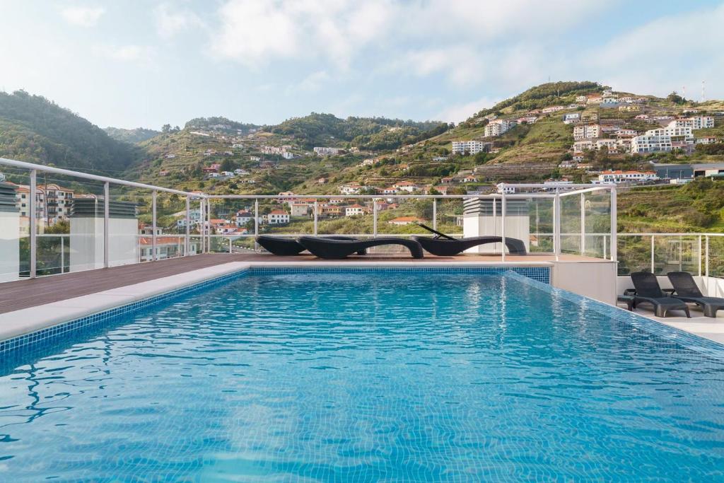 a swimming pool on the roof of a building at GuestReady - Calm Haven in Madeira in Caniço