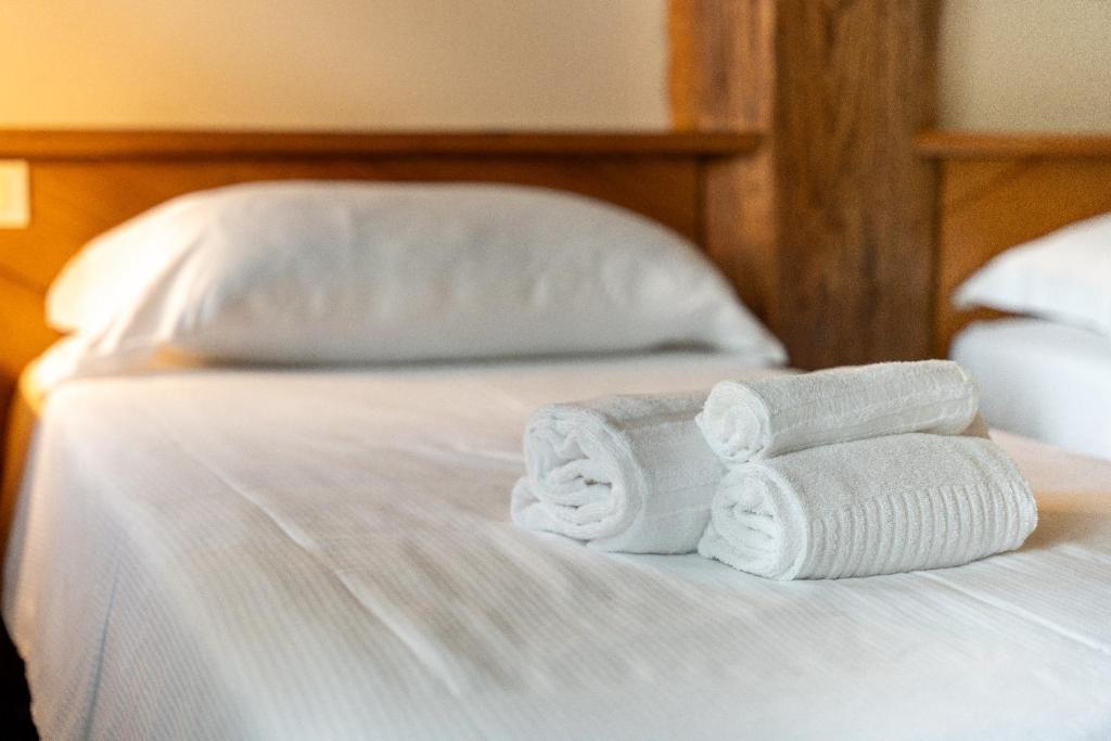 A bed or beds in a room at Locanda Al Cacciatore