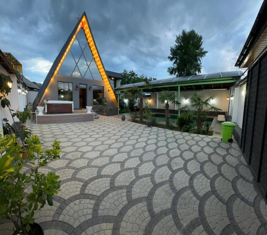 a building with a large geometric patterned courtyard at NatureNest A-Frame Cabin in Gabala