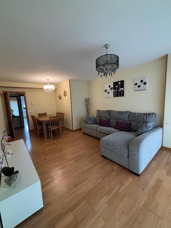 a living room with a couch and a table at Alojamiento Morriña in O Pedrouzo