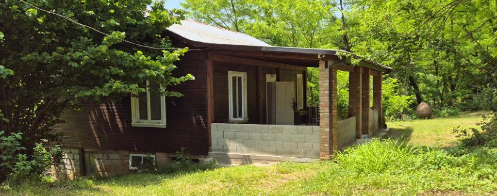 Cozy Wooden House in Shrosha, Imereti的田间中的小房子
