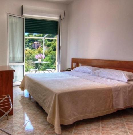 Postel nebo postele na pokoji v ubytování Hotel Primo Sole