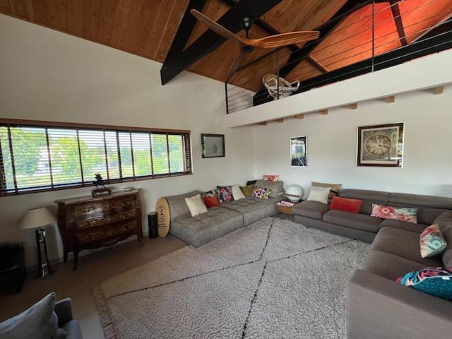 a large living room with couches and a piano at Belle Villa Terra Mare classée 4 étoiles entre océan et bassin in Lège-Cap-Ferret