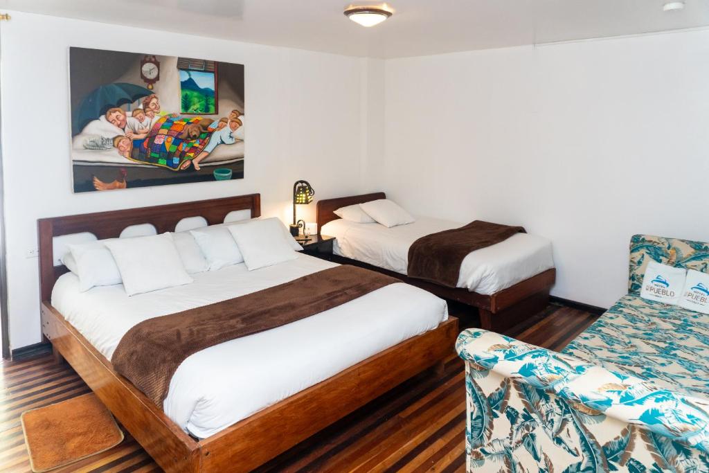Postel nebo postele na pokoji v ubytování Hotel De Mi Pueblo