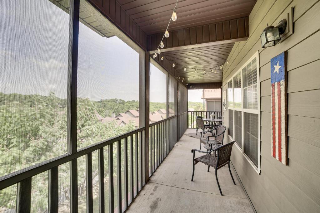 a balcony with chairs and tables on the side of a building at Pool and Lake Access Cozy Nest in Branson West in Branson West
