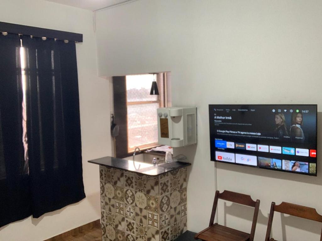 um quarto com um lavatório e uma televisão na parede em Centro, Maracanã privado total, SmarTV, vista panorâmica no Rio de Janeiro