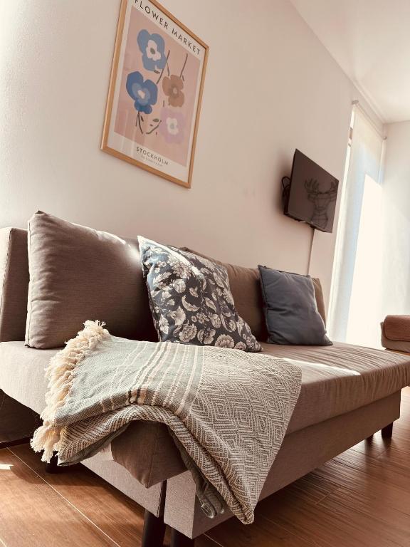 a couch with a blanket on it in a living room at Studio Apartman Nomad Divčibare in Divčibare