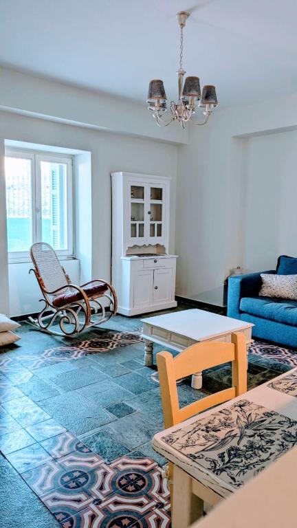 a living room with a couch and a table at Stellinas House 2 in Andros