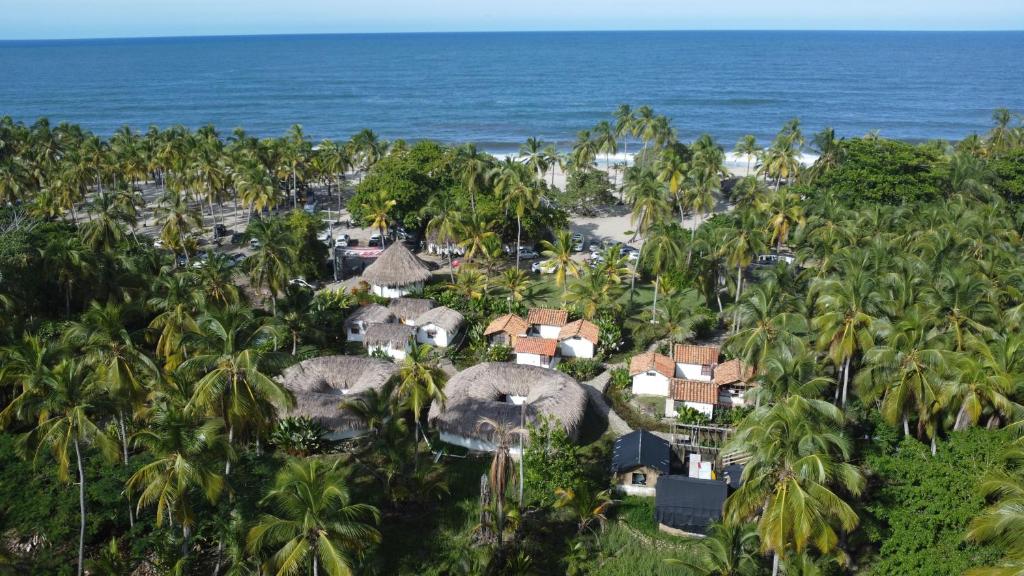 an aerial view of a resort with palm trees and the ocean at Playas De Casa Grande in Santa Marta